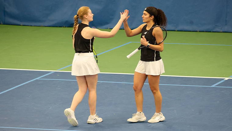 Two women's tennis players giving a high five